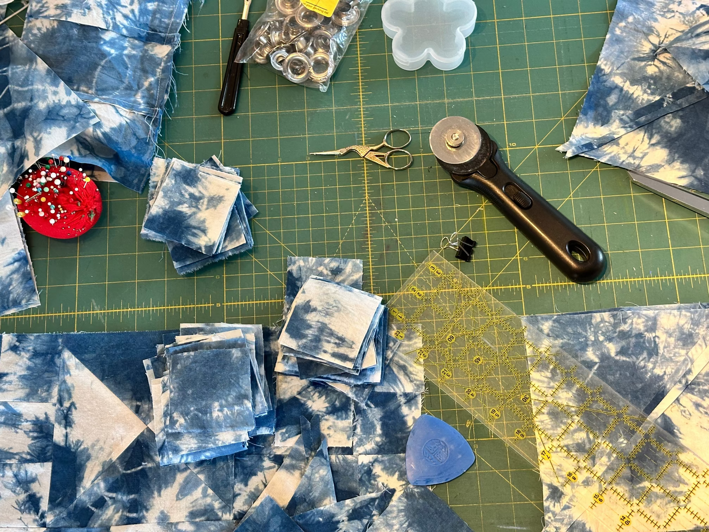 Quilting materials and tools on a green cutting mat