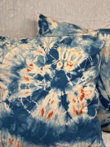 Close up of Hand-dyed indigo shibori pillow cases with sand dollar design