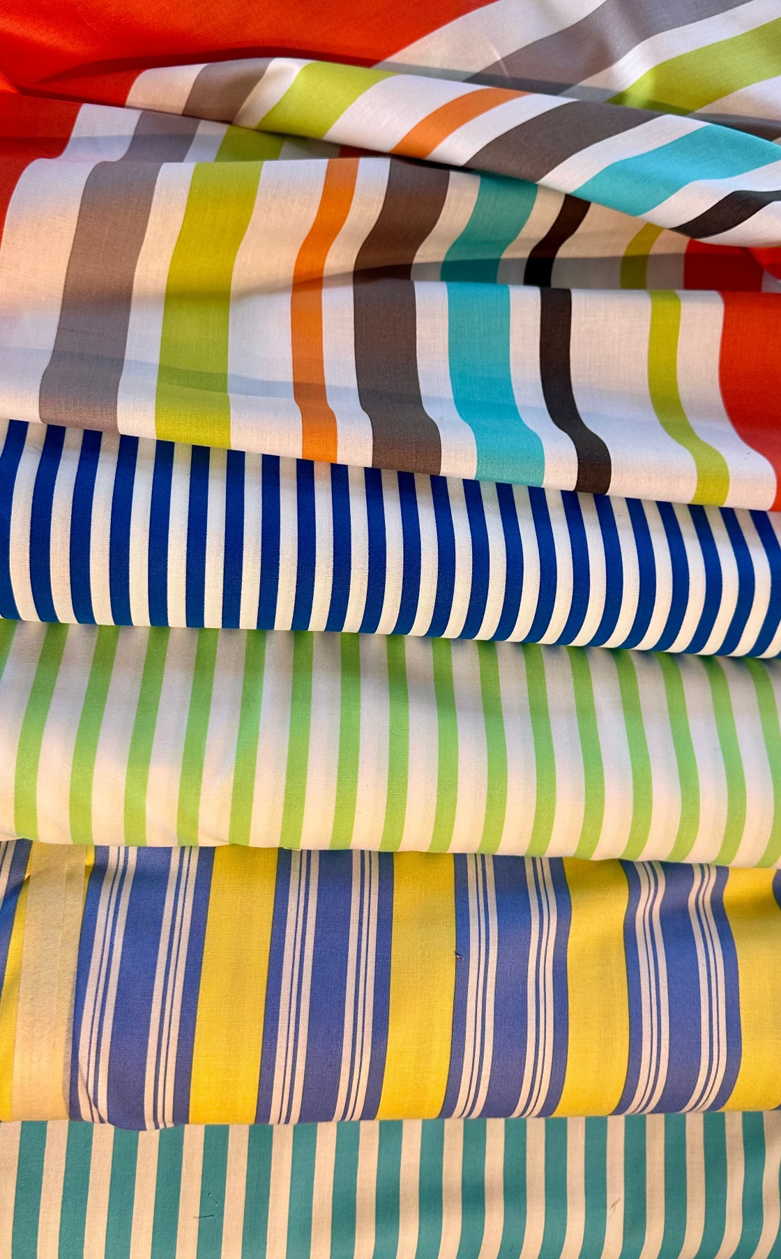 Stack of colorful striped fabric swatches